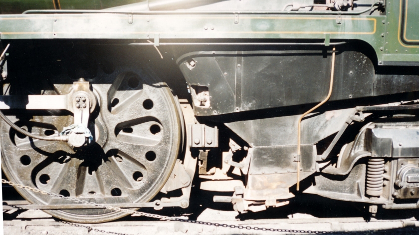 Merchant Navy class 35027 'Port Line' at the Bluebelle Railway in the early 2000s: close-up shot of the rear driving wheel, ash pan and rear pony truck.