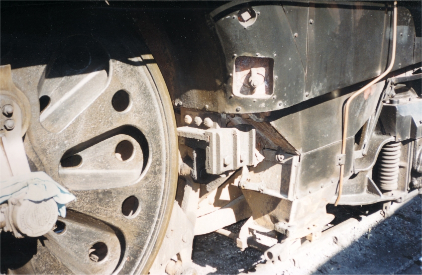 Merchant Navy class 35027 'Port Line' at the Bluebelle Railway in the early 2000s: three quarters close-up shot of the rear driving wheel, ash pan and rear pony truck.