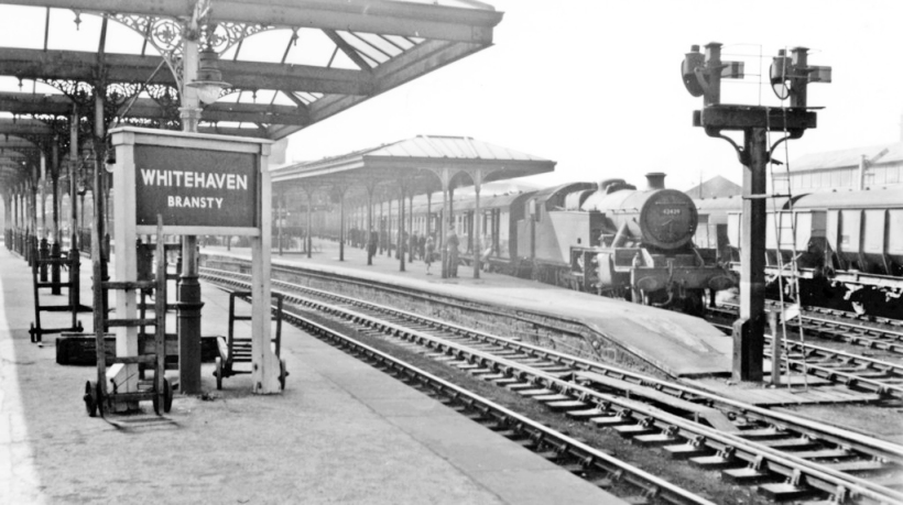Whitehaven (Bransty) station, with train for Carlisle 1954. View southward in the ex-LNW & Furness Joint station, towards Whitehaven (Corkickle), Barrow-in-Furness and Carnforth, by the former Furness Railway. The Carlisle train in the bay is headed by Stanier 4MT class 2-6-4T No. 42429 (built 1937, withdrawn 9/62). Photographer Walter Denby.