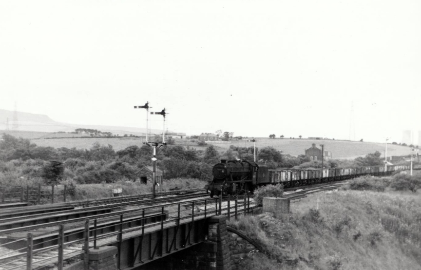 Stanier 8F 48423 approaches Rose Grove with a train of empty mineral wagons off the Accrington line on 22 July 1968.
