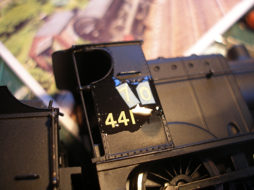Renumbering of a Hornby 4F ready-to-run loco using Fox Transfers; the replacement Fox Transfers numbers have been cut from the sheet and placed on the cab side with a drop of water
