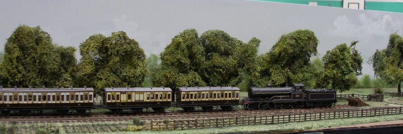 Guy William's Aylesbury (18.2mm gauge) showing the goods yard headshunt as it passes along Stocklake, complete with passenger train and loco 'parked up'.