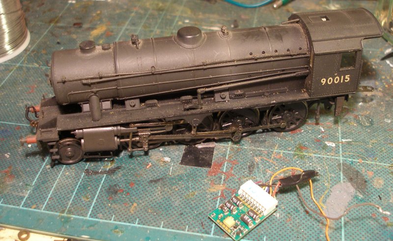 Bachmann WD Austerity 2-8-0 after being fitted with  a Zimo MX600R which has been 'hard wired' into the loco. The faulty Lenz 1025 which had been removed lies on the bench in front of it.