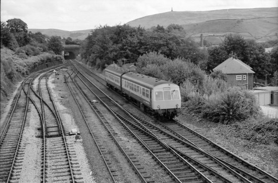 A two-car Class 101 in BR blue and grey passes the site of Hall Royd Junction signal cabin heading for Manchester on 5 September 1984