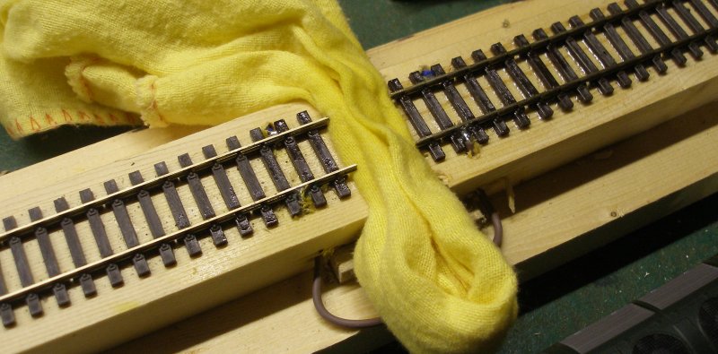 Construction of an OO gauge locomotive wheel cleaning track: Stage 3 a duster inserted between the two rail sections