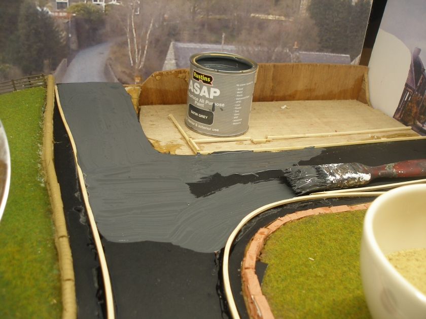 Construction of a 4mm model road: Step 10 Satin Grey paint being applied to the road surface.