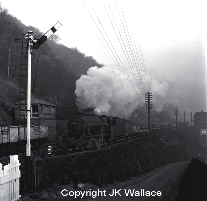 Stanier 8F 48319 passing Eastwood signal box near Todmorden on a westbound pickup freight 10.50 a.m. on Saturday 28 December 1963.