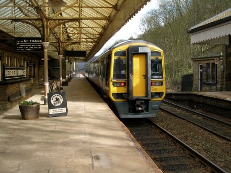 Class 158, number 158 844 departs in the Leeds direction in the afternoon of 19 April 2013 from Hebden Bridge railway station