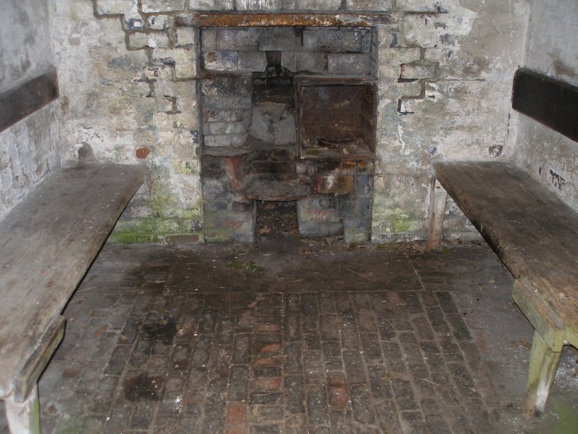 L&NWR Hartington Permanent Way Hut 10 July 2014 interior showing floor, benches and hearth.