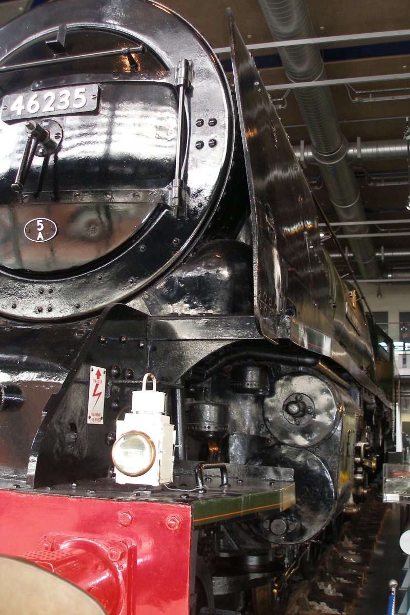 Stanier 'Coronation' Pacific 46235 'City of Birmingham' as seen in the ThinkTank Museum on 10 October 2015, showing the smokebox front and  smoke deflector, with a view down the towards the cab.