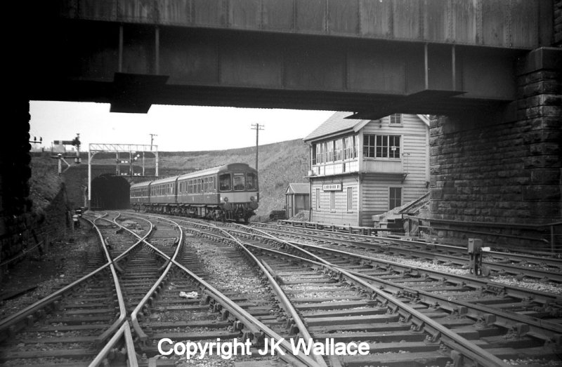 Low Moor No 1 Signal Box c. 1962 with a 2-car Class 110 unit passing towards Bradford showing the LNWR-style gallows signal.