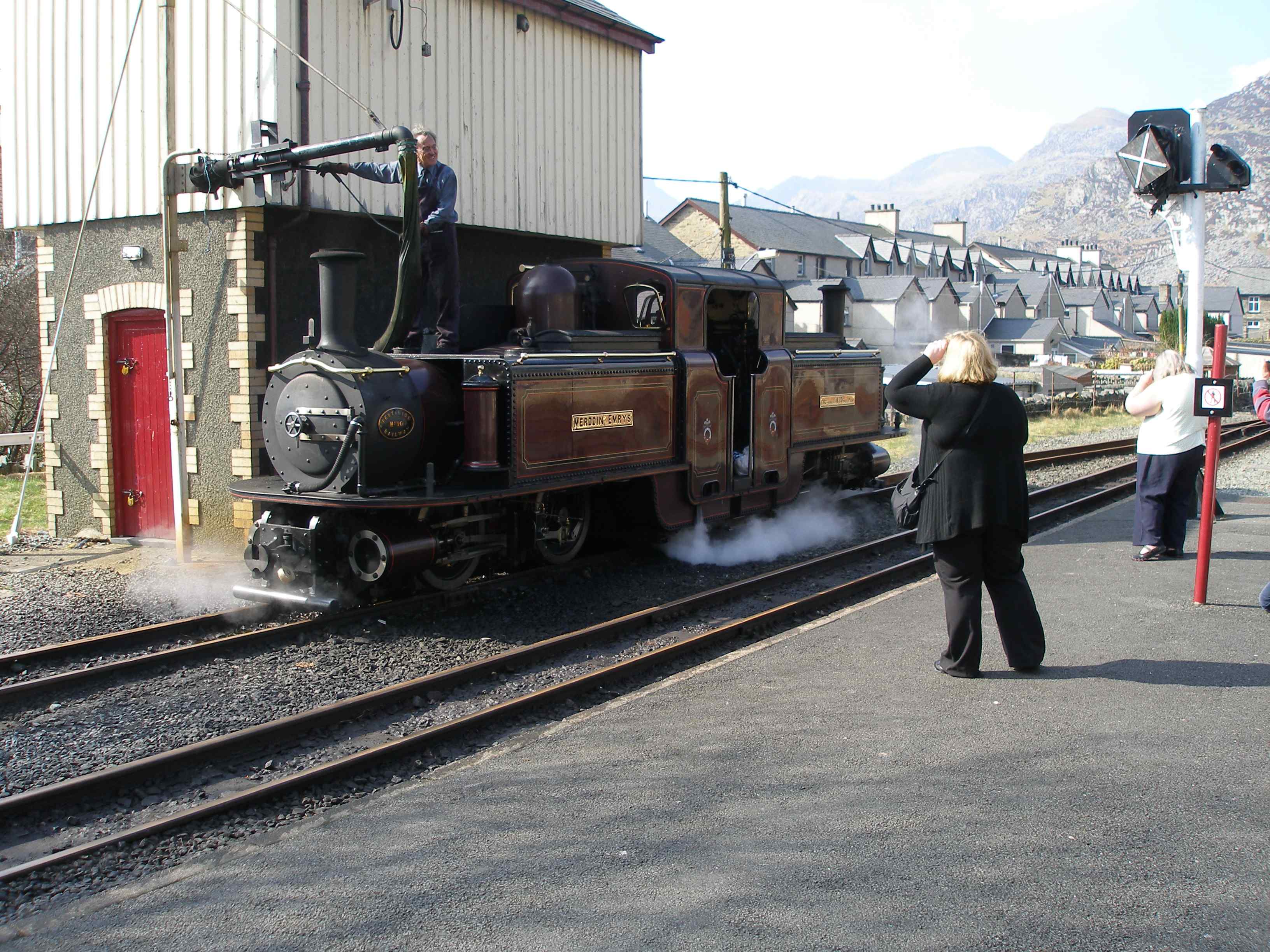 'Merddin Emrys' takes water at Blaenau Ffestiniog. Note the wooden cladding to protect the tank at this exposed location.