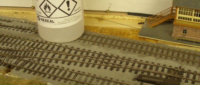 Loose ballast brushed around the sleepers of the PECO Streamline Bullhead OO scale Code 75 Unifrog point (turnout) after it had been laid on the layout.