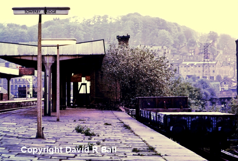 Sowerby Bridge railway station 1971: One of those great shots for modellers of an otherwise little photographed corner. This is the end of the Down Bay, looking towards Manchester. Note the two coal hoppers parked up in the goods yard beyond the station. 