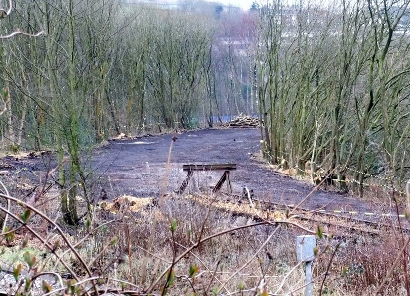 9 March 2012: Andrew Stopford's photograph shows the site of short curve linking the Calder Valley line to the Copy Pit line cleared ready to be re-instated. The Copy Pit line is crossing left to right in the foreground, and the viaduct leading to Todmorden Station, which carries the existing Calder Valley line, is visible centre right. The re-instated line will follow the excavated and cleared dark coloured formation curving towards the viaduct.