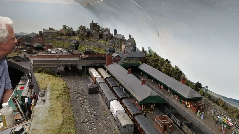 Thrlstone GC model railway: Thurlstone station with onlooker.