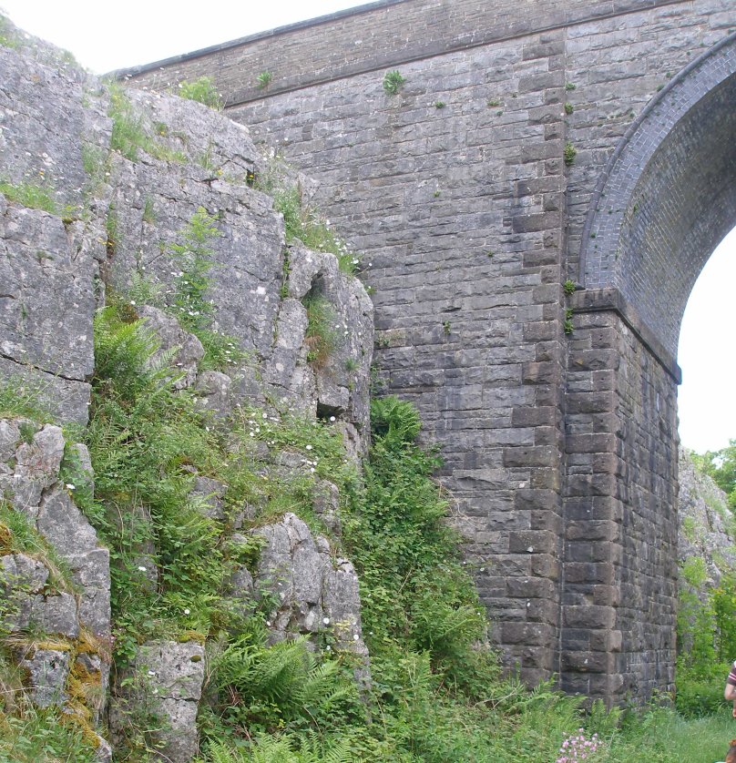 Tall bridge in rock cutting on the ex-LNWR line from Boxton to Ashbourne.