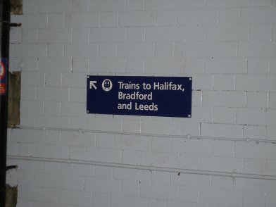 Todmorden Railway Staion sign on stairs to Platform 2 listing destinations