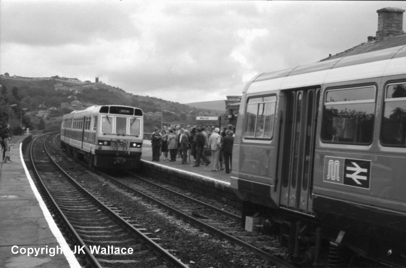 Summit Tunnel was reopened to traffic on 19 August 1985, and on the day two two-car Pacer Trains were caught in the Up platform at Todmorden. The nearer unit is 142001, whilst a Class 141 stands behind it.