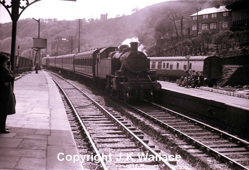 Ivatt Class 2 2-6-2T arrives at Todmorden from the Manchester direction with a 4-coach rake of compartment stock and two parcels vans.