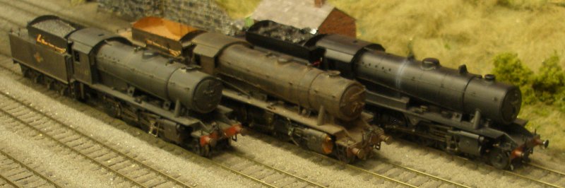 Comparison photograph showing the Bachmann WD Austerity 2-8-0 (left); the DJH kit-built model (centre) and the Bachmann WD Austerity Western Region version featuring the tall top-feed cover and covered fire iron tunnel.