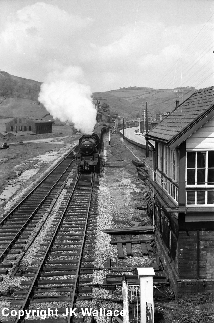Stanier Black 5 4-6-0 44947 passes Walsden signal box heading towards Manchester on 18 May 1968 with a loaded mineral train of coal.