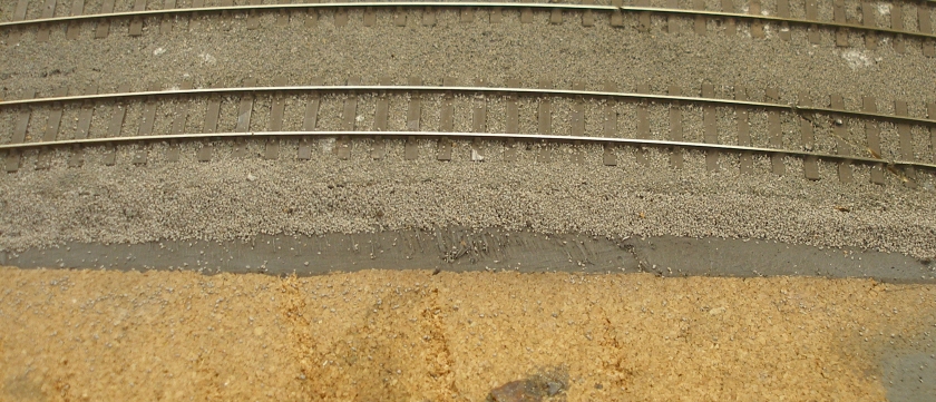 Model railway: Creation of a track cess, grassed areas and fencing: ballast edging formed in the cess