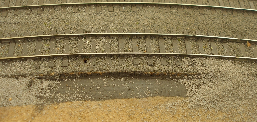 Model railway: Creation of a track cess, grassed areas and fencing: drainage cess cut into the cork underlay