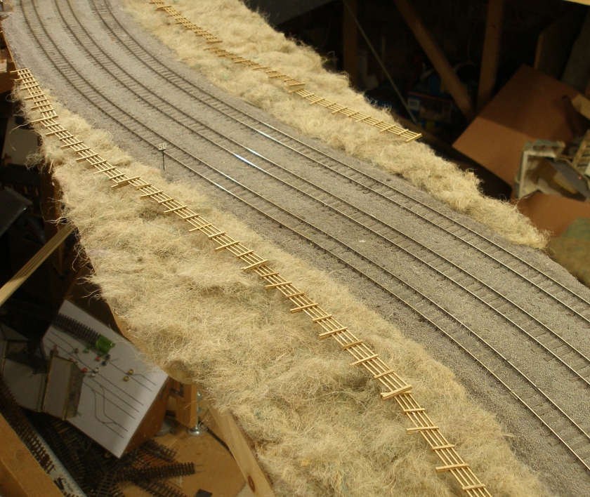 Model railway: Creation of a track cess, grassed areas and fencing: SMS fencing laid out ready to be fixed in place
